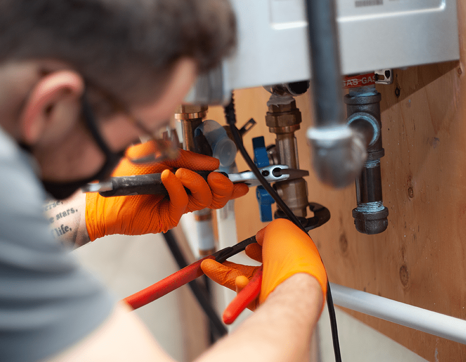 Plumber repairing a tankless water heater
