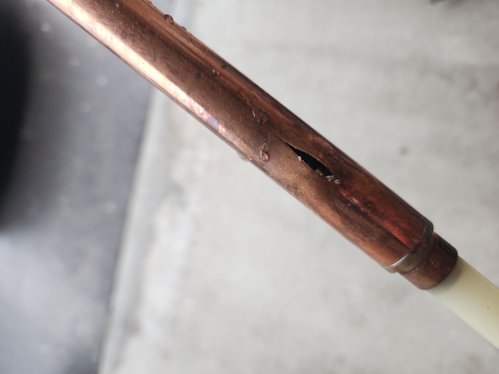 Burst plumbing pipe damaged by freezing water
