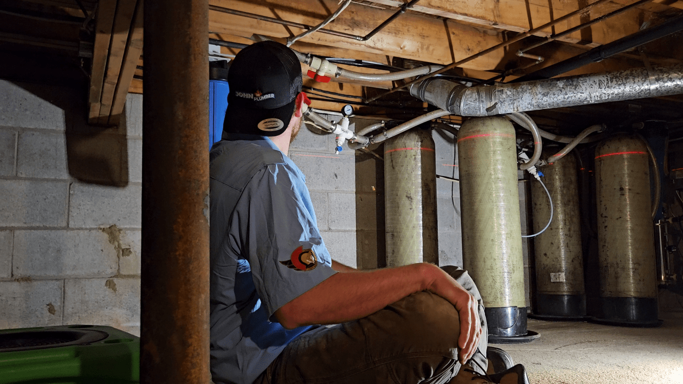 Ottawa plumber surveying an exposed residential plumbing system during a plumbing inspection