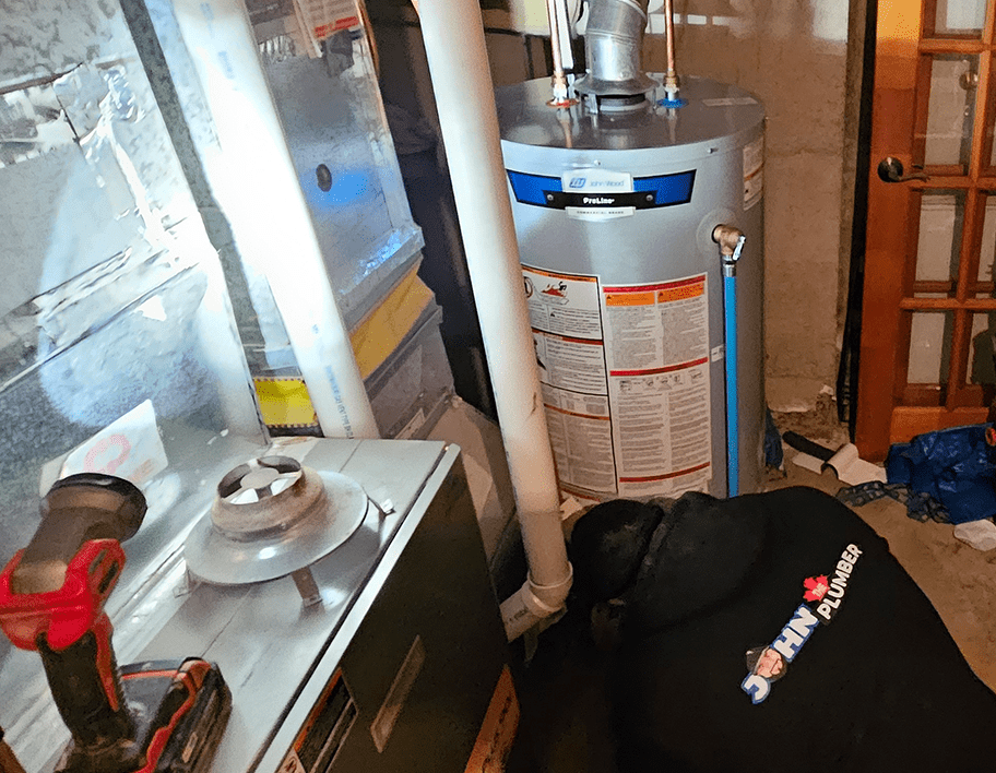 plumber working on gas water heater ottawa west