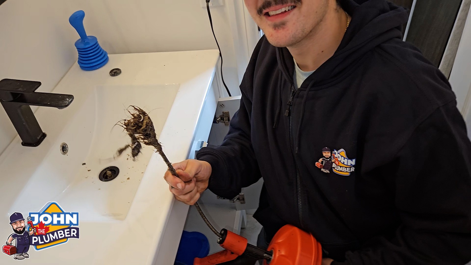 Plumber removing a blockage during drain cleaning service