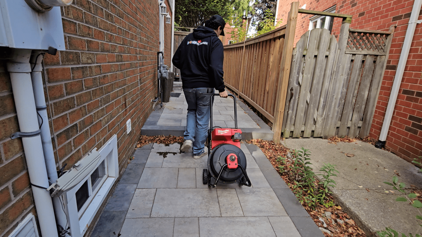 John The Plumber technician arriving with professional drain cleaning equipment in Hamilton