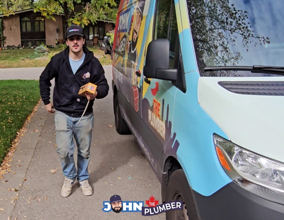 John The Plumber plumber beside a company service van in Hamilton