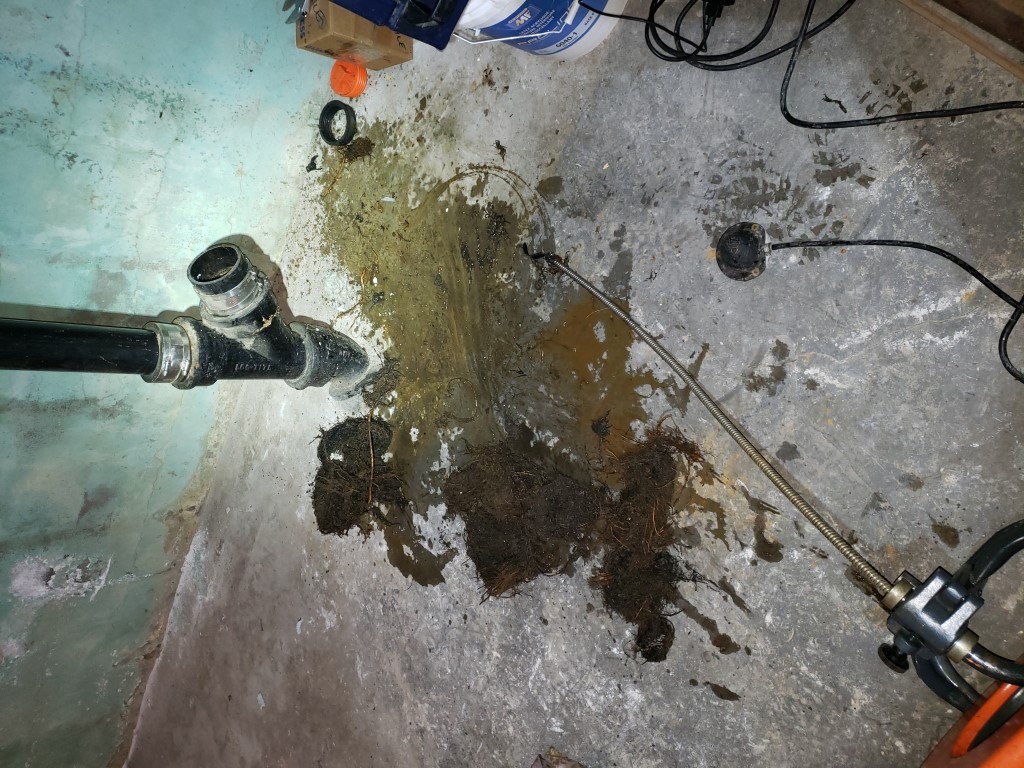 Plumber cleaning a blocked sewer line in Hamilton